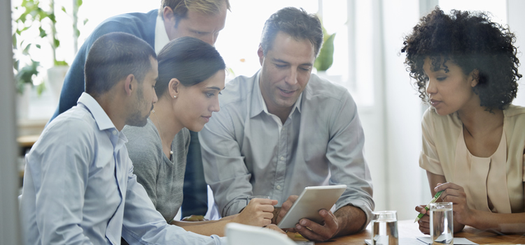 Photo of business team browsing tablet for ideas